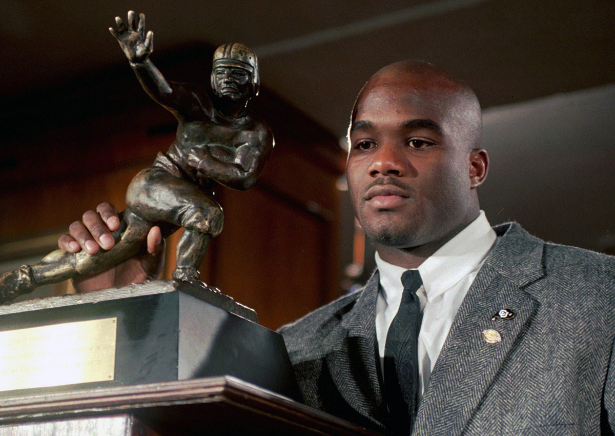In this Dec. 10, 1994, file photo, Colorado's Rashaan Salaam poses with his 1994 Heisman Trophy at the Downtown Athletic Club in New York. 