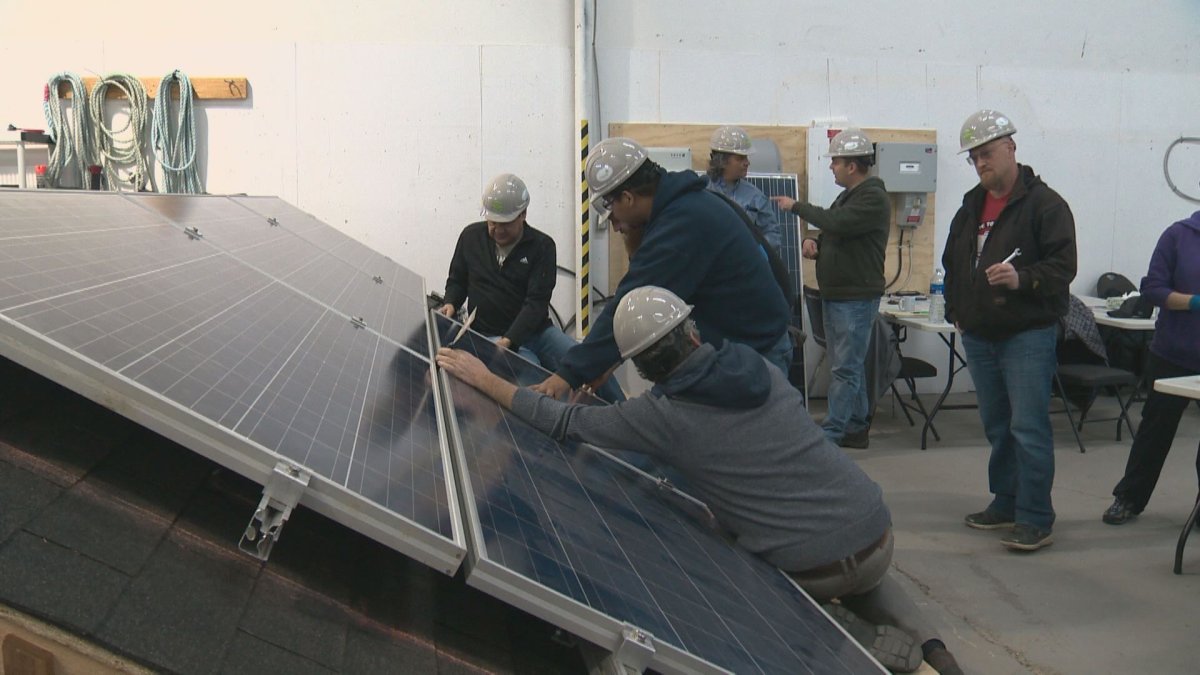 Students learn how to install solar energy grids.