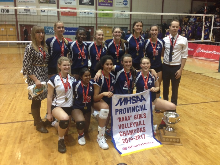 The St. Mary's Flames pose with their championship banner after winning the AAAA Girls High School Volleyball Championship.