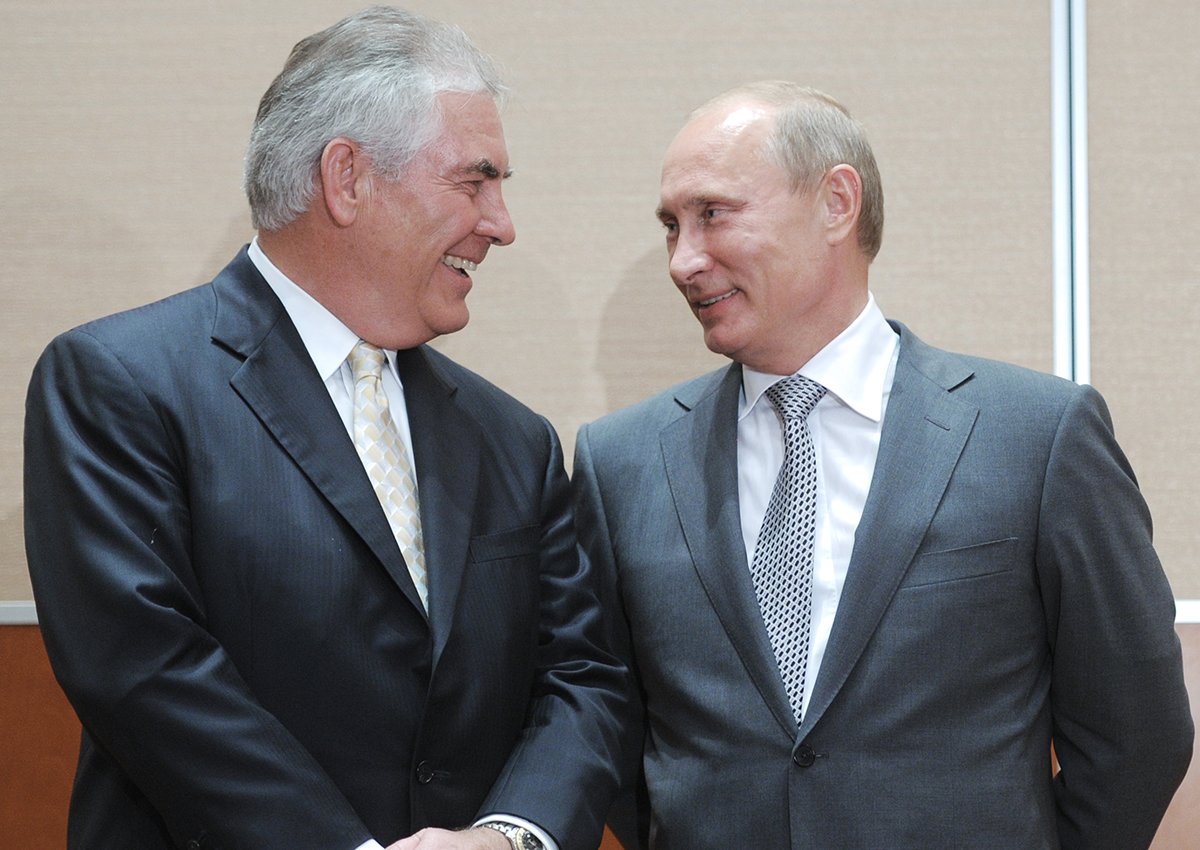 Russia's Prime Minister Vladimir Putin speaks with ExxonMobil President and Chief Executive Officer Rex Tillerson during the signing of a Rosneft-ExxonMobil strategic partnership agreement in Sochi on August 30, 2011. 