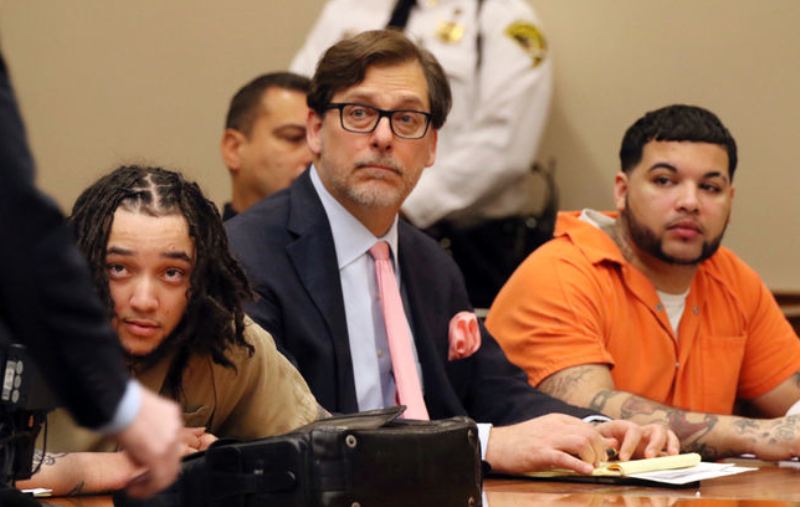 Elliot Rivera, right, Peter Pullano, defense attorney for Dennis Perez, and Dennis Perez, left, listen as Leah Gigliotti's lawyer, Brian DeCarolis speaks in Monroe Supreme Court in Rochester, N.Y., Wednesday, Nov. 23, 2016, during the sentencing for their role role in the kidnapping and torturing of two college students in Rochester last year. (Tina MacIntyre-Yee/Democrat & Chronicle via AP).