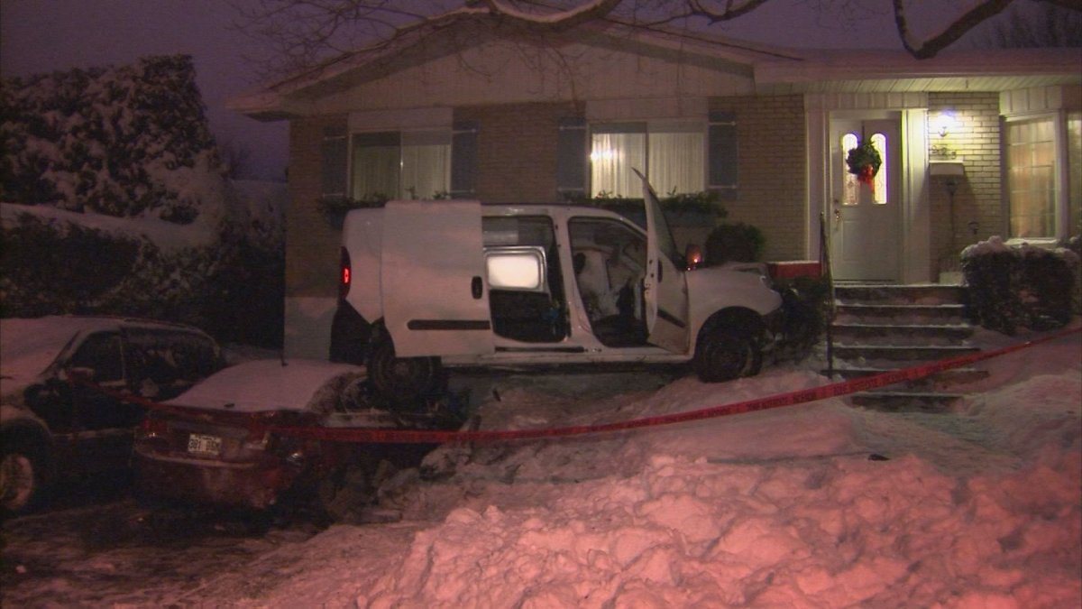 A mini-van is partially perched on a parked car and the front lawn of a private residence in Châteauguay after the driver lost control and crashed. Tuesday, Dec. 13, 2016.