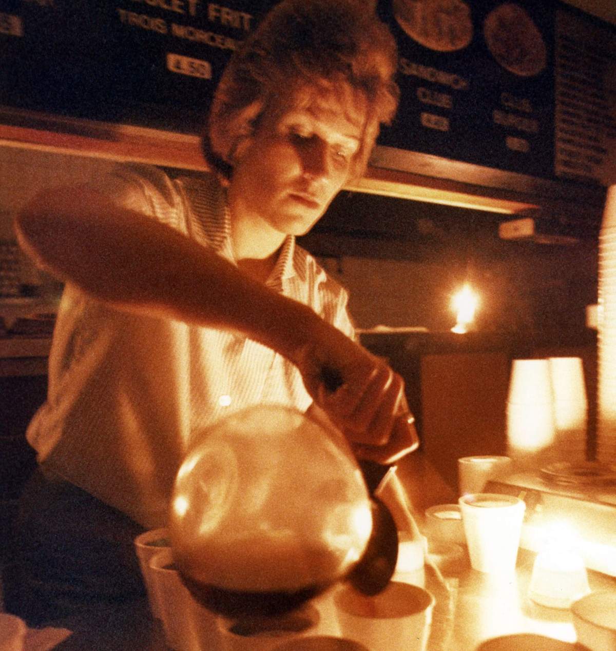 Francine Perreault serves coffee by candlelight at L’Express Deli-Burger in Montreal on March 13, 1989.
