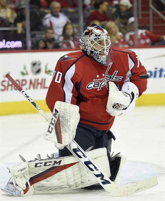 Washington Capitals goalie Braden Holtby stops the puck during the second period of an NHL hockey game against the Vancouver Canucks, Sunday, Dec. 11, 2016, in Washington.