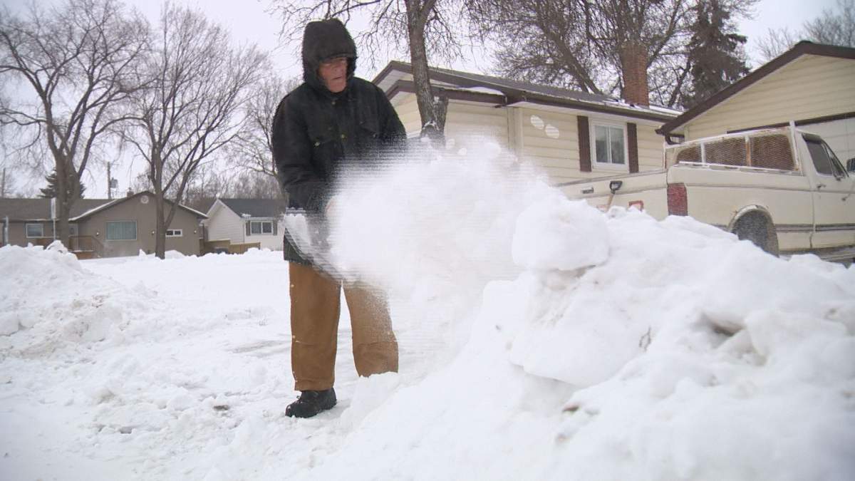 Raymond Pretty shovels his driveway.