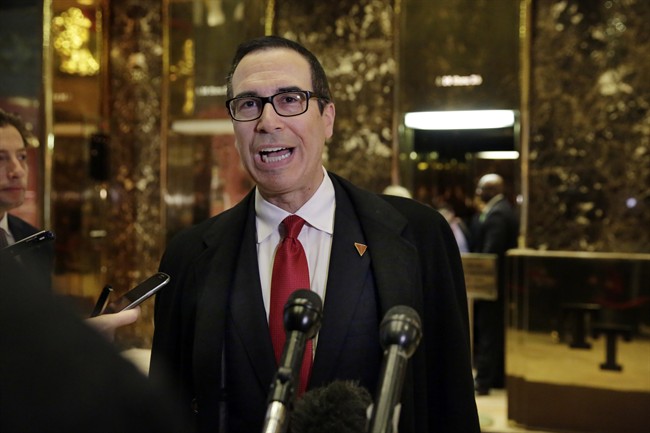 In this Nov. 30, 2016 file photo, Treasury Secretary-designate Steven Mnuchin talks to reporters as he arrives at Trump Tower in New York.
