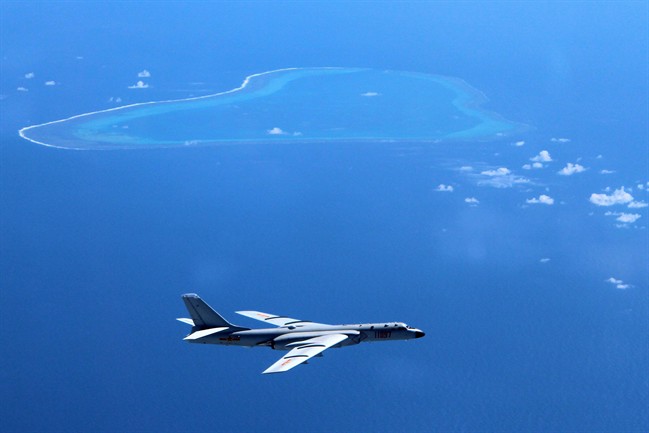 FILE - In this undated file photo released by Xinhua News Agency, a Chinese H-6K bomber patrols the islands and reefs in the South China Sea. (Liu Rui/Xinhua via AP, File).