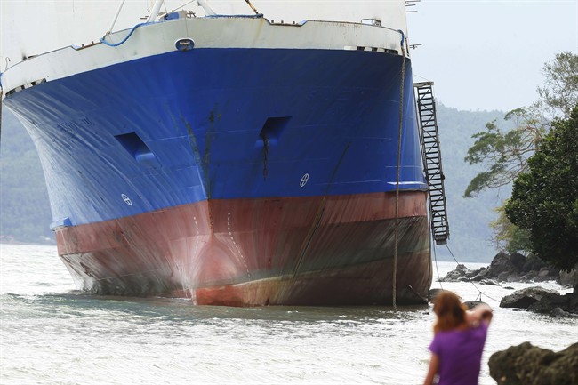 The passenger ferry Shuttle Roro 5 is shown resting by shoreline after being swept by typhoon Nock-Ten a day after Christmas Monday, Dec. 26, 2016 at Mabini township, Batangas province, south of Manila, Philippines. The powerful typhoon slammed into the eastern Philippines on Christmas Day, spoiling the biggest holiday in Asia's largest Catholic nation but weakened slightly on Monday as it roared toward a congested region near the country's capital, officials said.