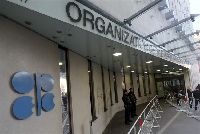 Persons stand outside the headquarters of the Organization of the Petroleum Exporting Countries, OPEC, in Vienna, Austria, Saturday, Dec. 10, 2016.