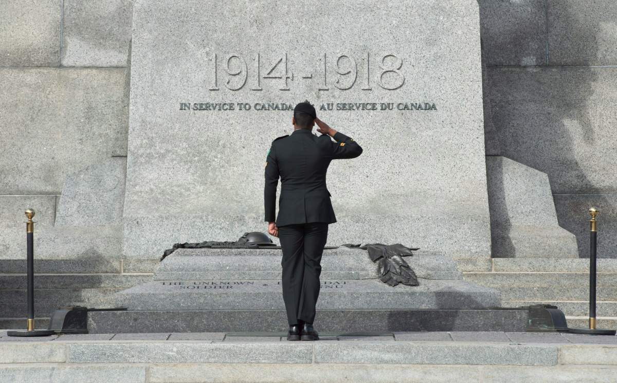 A member of the Canadian Forces salutes as he passes in front of the Tomb of the Unknown Soldier at the National War Memorial in Ottawa, Wednesday Oct. 22, 2015. A ceremony will be held Thursday to mark the one year anniversary of a shooting at the memorial which killed Cpl. Nathan Cirillo.