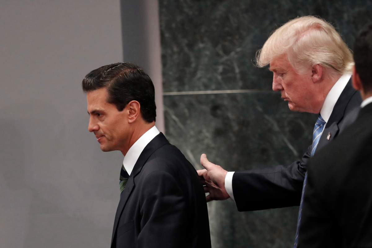 In this Aug. 31, 2016 file photo, Republican presidential nominee Donald Trump walks with Mexico President Enrique Pena Nieto at the end of their joint statement at Los Pinos, the presidential official residence, in Mexico City. Trump called his surprise visit to Mexico City a ‘great honor.’ A week later one of Nieto’s closest advisers and confidants, Finance Secretary Luis Videgaray, resigned in a move seen as linked to the unpopular decision to invite Trump to visit Mexico.