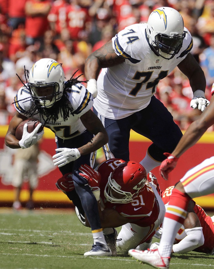 San Diego Chargers wide receiver Travis Benjamin (12) is tackled by Kansas City Chiefs linebacker Frank Zombo (51), with San Diego Chargers offensive guard Orlando Franklin (74) running in the rear, during the first half of an NFL football game in Kansas City, Mo., Sunday, Sept. 11, 2016. Franklin is looking to give back.The Los Angeles Chargers offensive lineman purchased the Scarborough Minor Football Association on Monday. It's the same program Franklin played for as a youth before moving to Florida, where he played high school football in Delray Beach. 