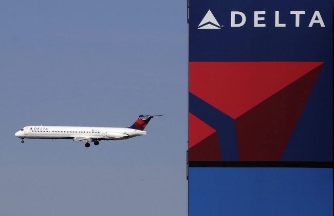 A Delta Airlines jet flies past the company's billboard at Citi Field, in New York in this April 6, 2013, file photo .
