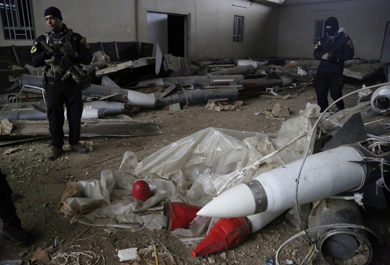 Iraq's special forces troops inspect missiles found in a warehouse in the eastern side of Mosul, Iraq, Jan. 28, 2017. 