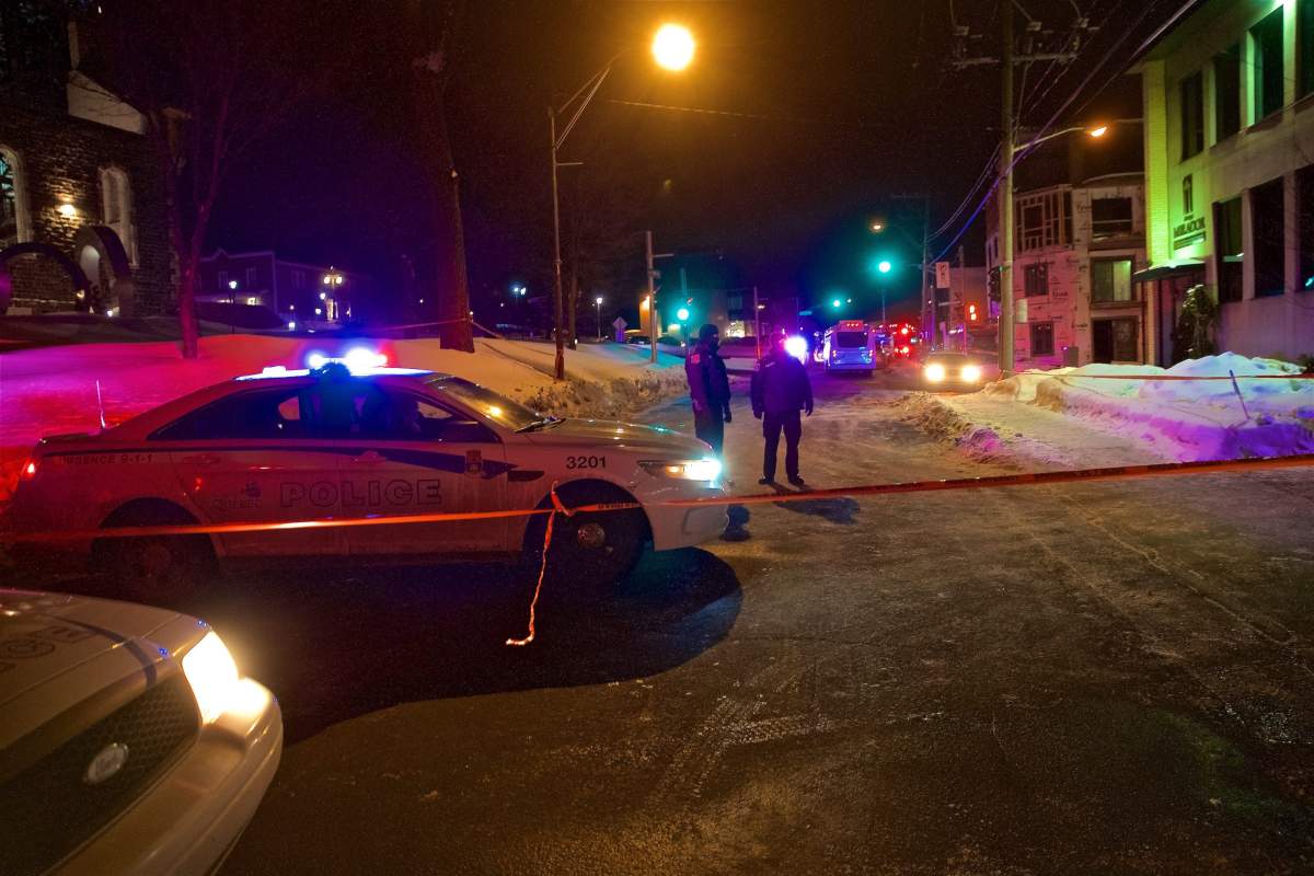Quebec Provincial and municipal police officers are seen behind a cordoned off area after two gunmen reportedly opened fire at the Quebec Islamic Cultural Centre in Quebec City, Quebec, Canada, 30 January 2017. According to the police, six people were killed and another eight were wounded in a shooting at a Mosque during evening prayers on 29 January. Two suspects have been taken into custody.