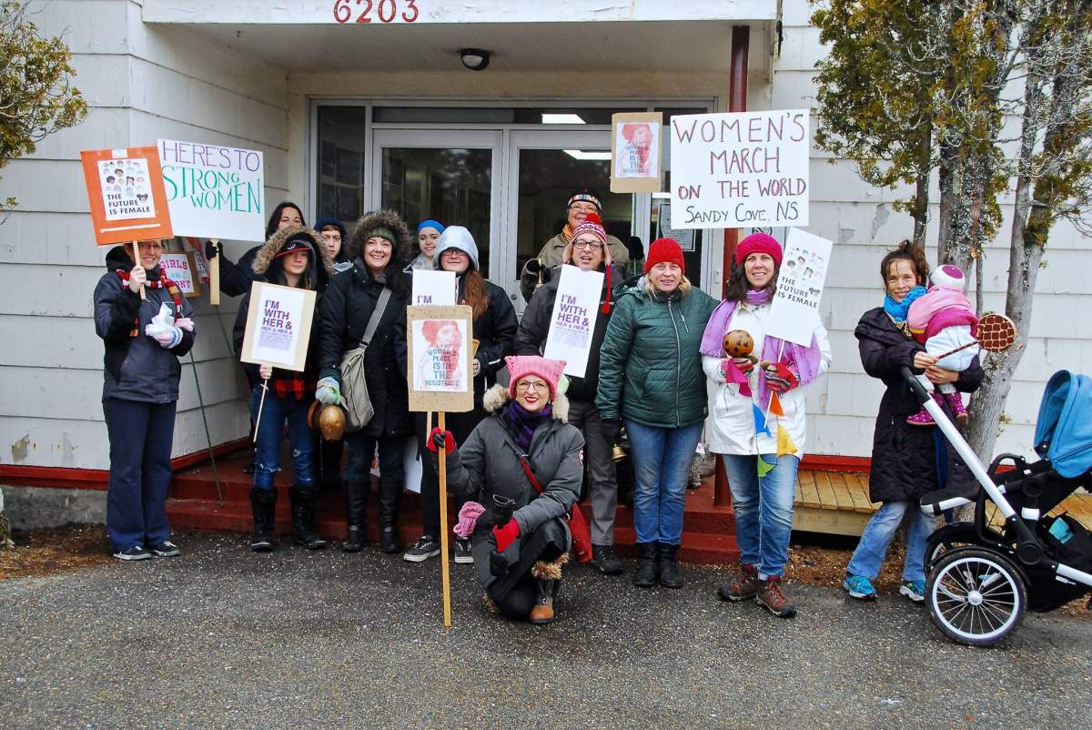 A small group of men and women smile for a camera during a march in Sandy Cove, N.S. on Saturday, Jan. 21, 2017. The march was in solidarity with the Women’s March on Washington being held the same day. (Photo: Gary Wilson/Facebook)