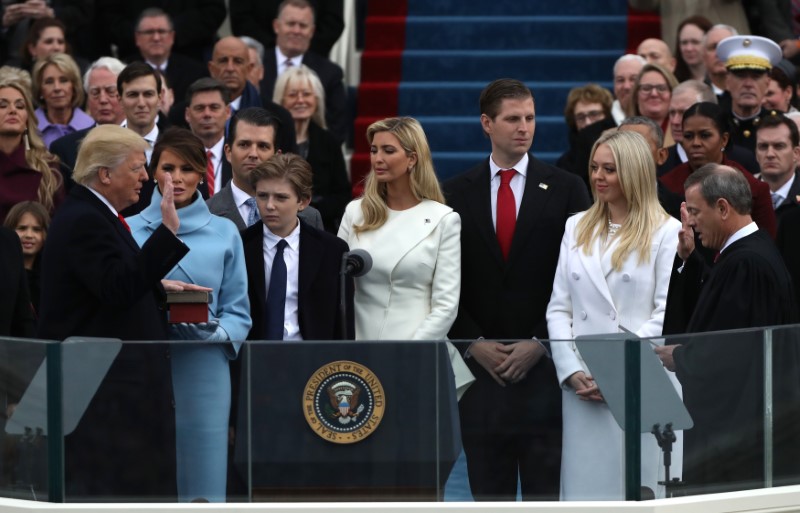 U.S. President Donald Trump (L) takes the oath of office from U.S. Supreme Court Chief Justice John Roberts (R) with his wife Melania, and children Barron, Donald, Ivanka and Tiffany at his side during inauguration ceremonies at the Capitol in Washington, U.S., January 20, 2017.