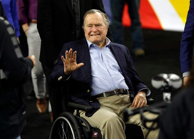 In this April 2, 2016, file photo, former President George H. W. Bush waves as he arrives at NRG Stadium before the NCAA Final Four tournament college basketball semifinal game between Villanova and Oklahoma in Houston.
