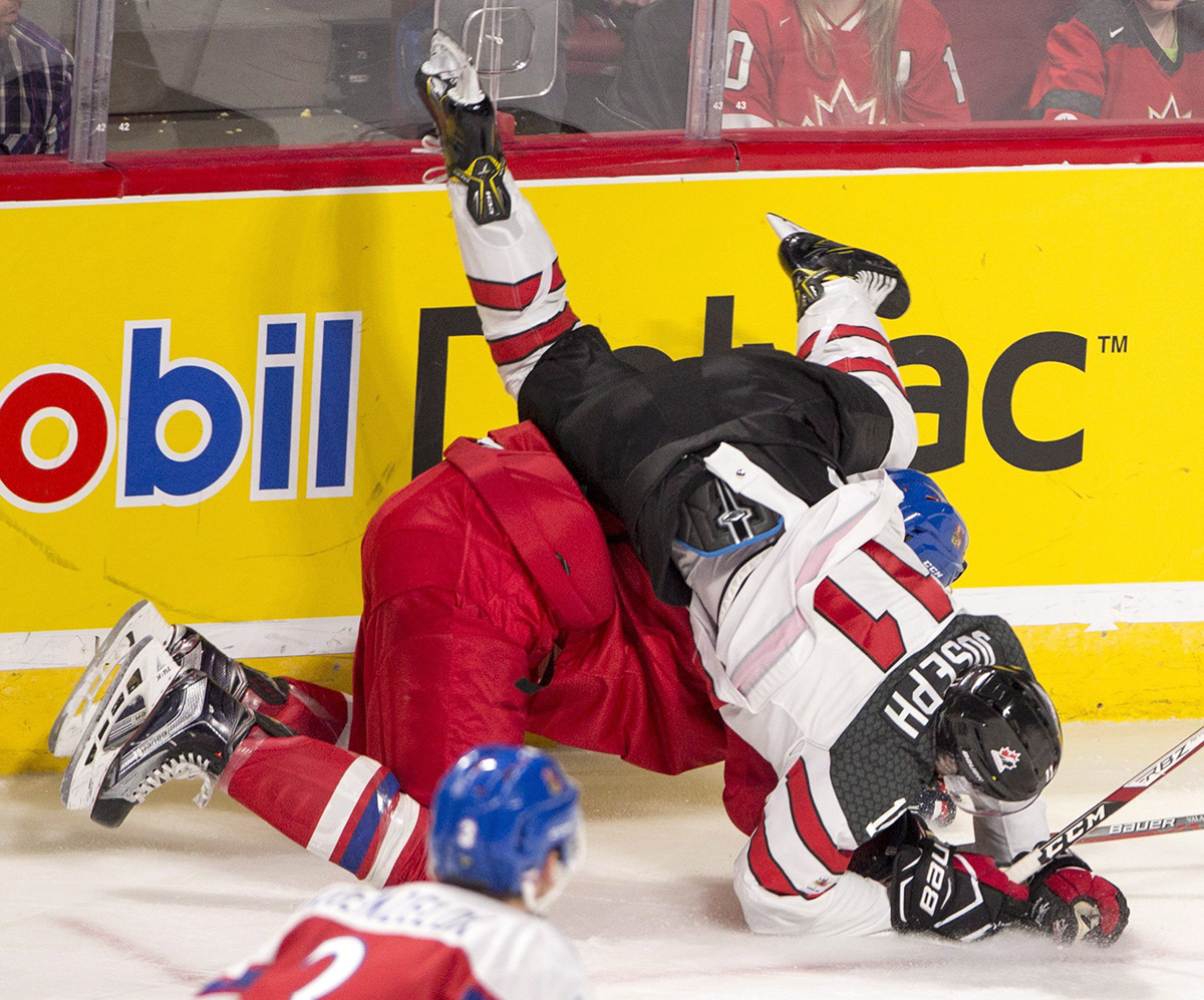 Canada forward Mathieu Joseph (11) is checked by Czech Republic defenceman Ondrej Vala (6) during second period quarter-final IIHF World Junior Championships hockey action Monday, January 2, 2017 in Montreal. THE CANADIAN PRESS/Ryan Remiorz