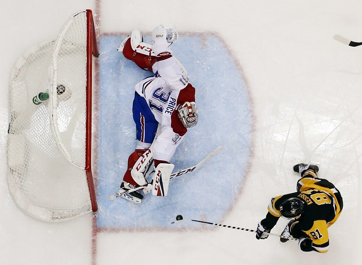 Pittsburgh Penguins' Phil Kessel (81) backhands a shot past Montreal Canadiens goalie Carey Price (31) for a goal during the second period of an NHL hockey game in Pittsburgh, Saturday, Dec. 31, 2016. The Penguins won 4-3. (AP Photo/Gene J. Puskar)