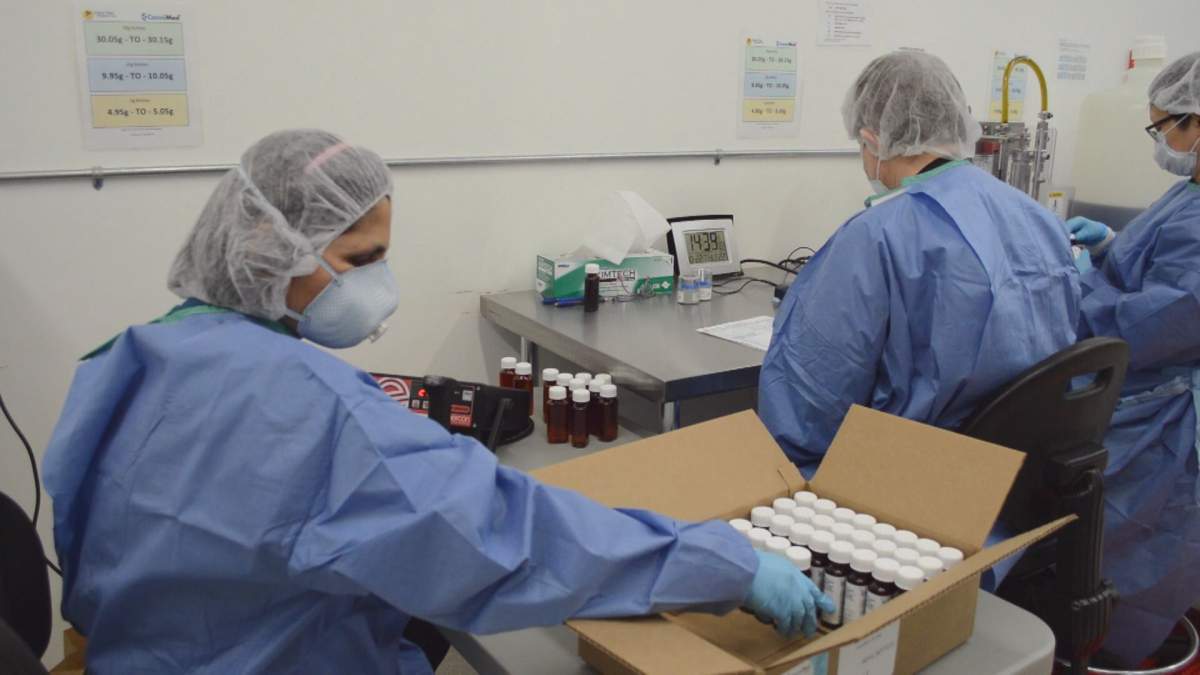 CanniMed workers prepare bottles of medicinal cannabis oil for shipment.