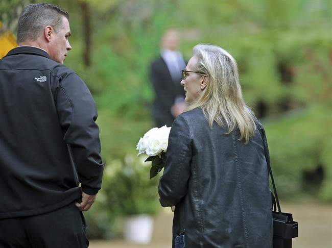 Actress Meryl Streep arrives with flowers at a memorial service at the homes of Debbie Reynolds and her daughter Carrie Fisher in Los Angeles Thursday, Jan. 5, 2017. Reynolds died Dec. 28 at the age of 84, a day after her daughter died at the age of 60. Streep starred in the film, "Postcards From the Edge," based on Fisher's 1987 semi-autobiographical novel of the same title.