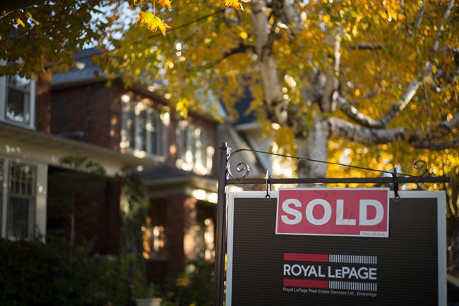 A real estate sold sign hangs in front of a west-end Toronto property Friday, Nov. 4, 2016. Toronto-area house prices continued to soar in December, and sales volume was up 8.6 per cent over the same month in 2015. 