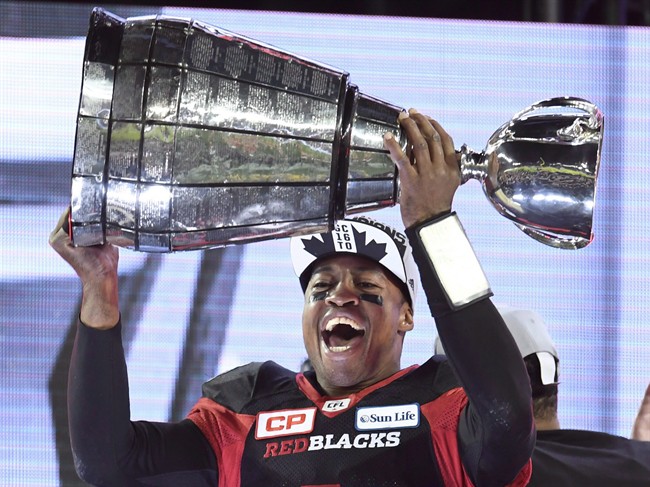 Ottawa Redblacks Henry Burris holds up the Grey Cup celebrating his team's win over the Calgary Stampeders in Toronto on Sunday, November 27, 2016. 