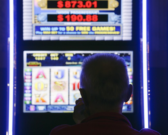 A man plays at a video lottery terminal at Tioga Downs, in Nichols, N.Y., in a Thursday, Oct. 16, 2014 file photo. 