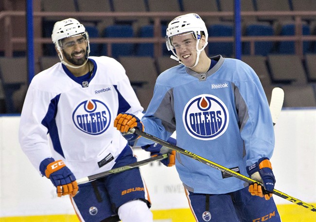 Edmonton Oilers' Connor McDavid (97) thas a laugh with teammate Jujhar Khaira (54) during practice, in Edmonton, Alta., on Wednesday January 6, 2016. The Oilers have recalled forward Khaira from the American Hockey League's Bakersfield Condors. 