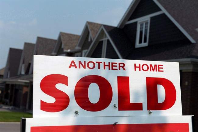 A for sale sign displays a sold home in a housing development in Ottawa on July 6, 2015.