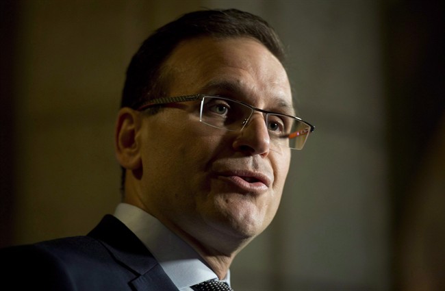 Senate Speaker Leo Housakos speaks with the media in the Foyer of the Senate on Parliament Hill in Ottawa, Tuesday, May 26, 2015. The chairman of the Senate committee charged with overseeing expense rules is firing back at the Liberal point man in the upper chamber over the level of accountability and transparency with senators' spending. THE CANADIAN PRESS/Adrian Wyld.