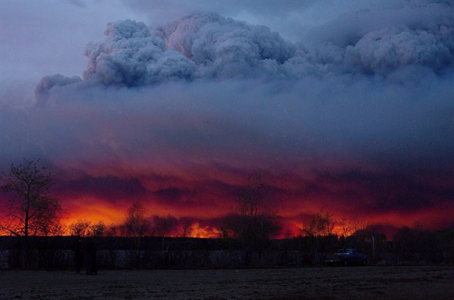 A wildfire moves towards the town of Anzac from Fort McMurray, Alta., on Wednesday May 4, 2016. An assessment of the total financial impact of last spring's Fort McMurray wildfire is pegging the direct and indirect costs of the blaze at almost $10 billion.THE CANADIAN PRESS/Jason Franson.