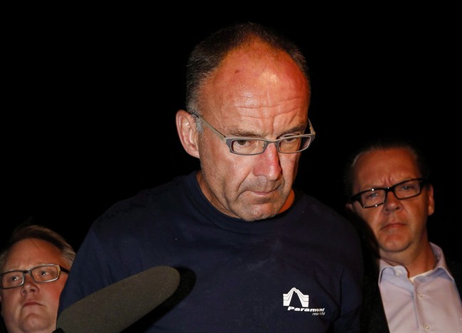 Douglas Garland is escorted into a Calgary police station in connection with the disappearance of Nathan O'Brien and his grandparents in Calgary, Alta., on July 14, 2014. 