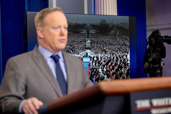 An image of the inauguration of President Donald Trump is displayed behind White House press secretary Sean Spicer as he speaks at the White House onJan. 21, 2017, in Washington.