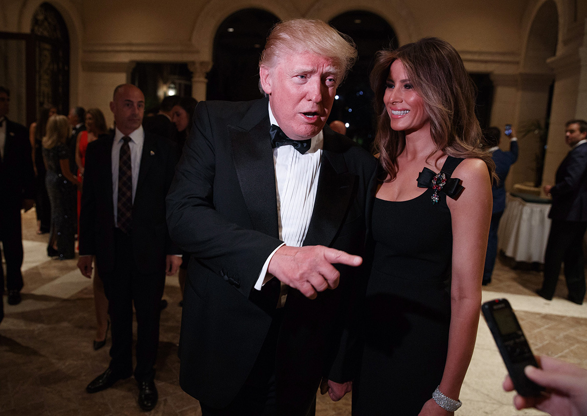 In this Dec. 31, 2016 file photo, Melania Trump, right, looks on as her husband President-elect Donald Trump talks to reporters during a New Year's Eve party at Mar-a-Lago, in Palm Beach, Fla.