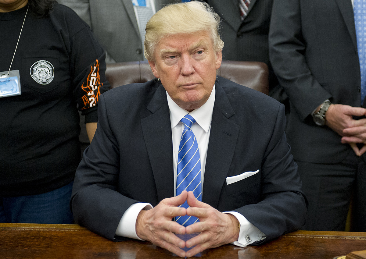 President Donald Trump poses for a group photo at a meeting with union leaders at the White House on January 23, 2017 in Washington, DC. 