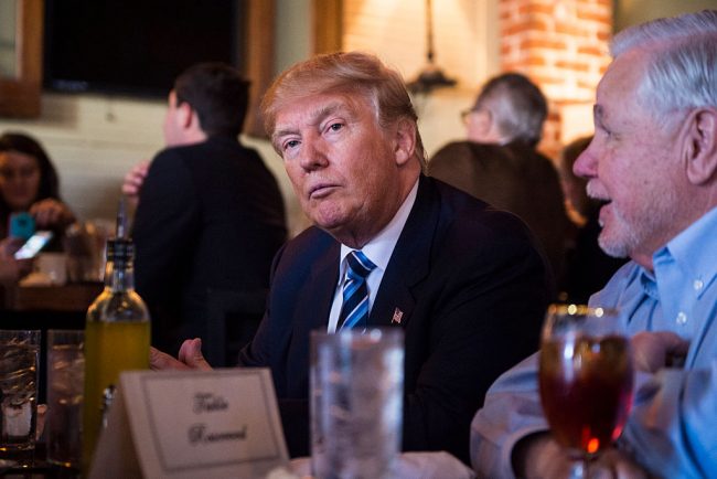 Donald Trump sits to eat with North Charleston Mayor Keith Summey while making a stop for lunch between campaign events at Fratello's Italian Tavern in North Charleston, SC on Thursday Feb. 18, 2016. 