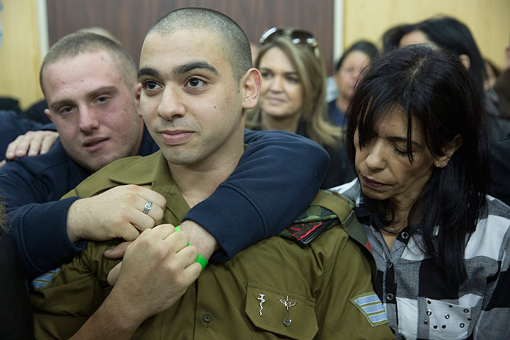 Israeli solider Sgt. Elor Azaria waits with his parents for the verdict inside the military court in Tel Aviv, Israel on Wednesday, Jan. 4, 2017.   