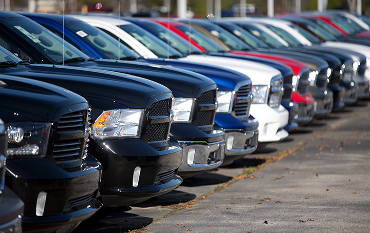 In this Jan. 5, 2015, file photo, Ram pickup trucks are on display on the lot at Landmark Dodge Chrysler Jeep RAM in Morrow, Ga. 