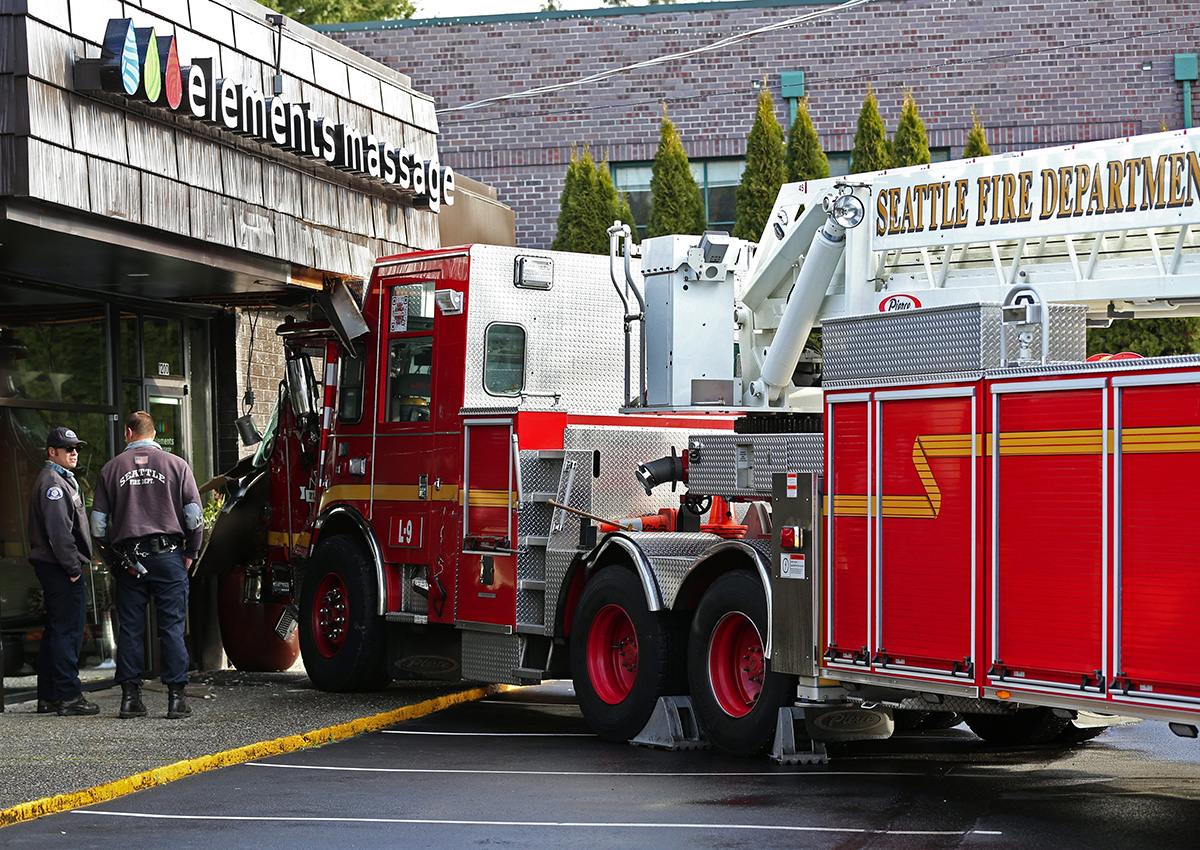 In this Sunday, Jan. 1, 2017, photo, officials respond after a collision between two Seattle firetrucks which sent several firefighters to the hospital in Seattle. 