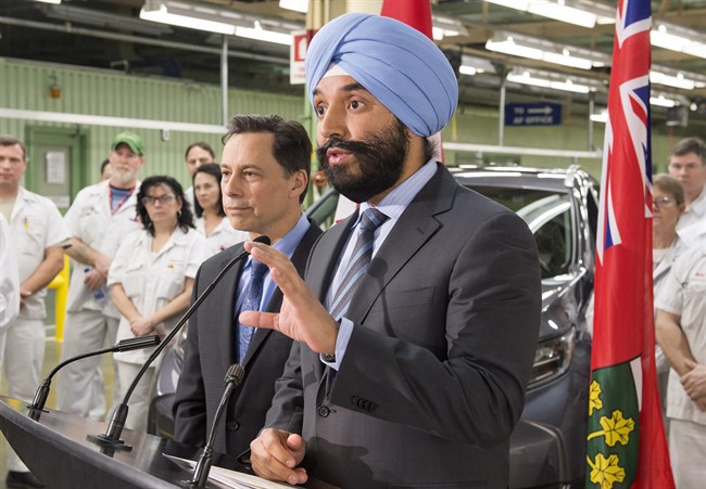 Navdeep Bains (right), Minister of Innovation, Science and Economic Development, together with the Brad Duguid (left), Ontario Minister of Economic Development and Growth make a funding announcement at the Honda manufacturing plant in Alliston, Ontario on Monday January 9, 2017 THE CANADIAN PRESS/Frank Gunn.