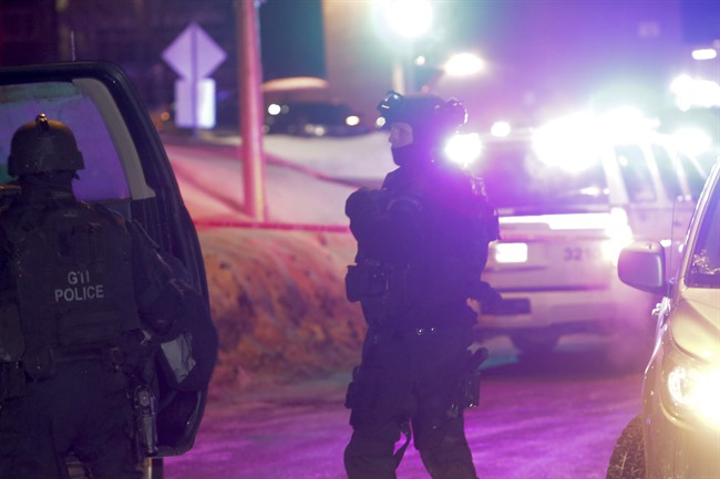 Police survey the scene of a shooting at a Quebec City mosque on Sunday January 29, 2017. 