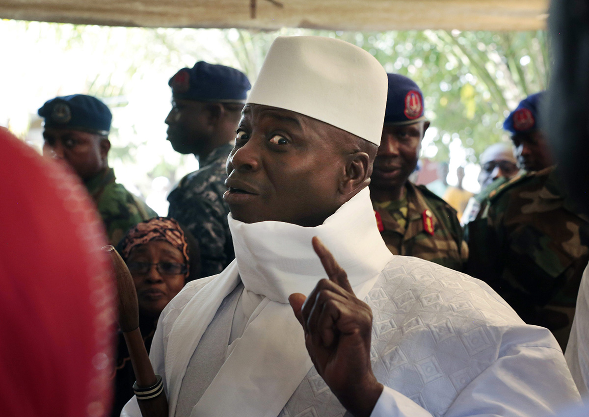 In this Thursday, Dec. 1, 2016 file photo, Gambia's President Yahya Jammeh shows his inked finger before voting in Banjul, Gambia. 