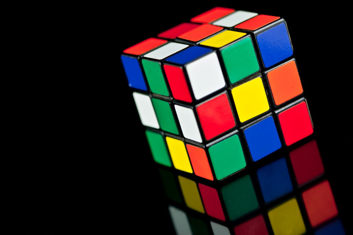 Rubik's Cube toy on black background with reflection.