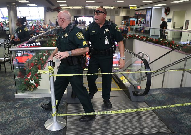 Broward County Sheriff officers exit from the escalator that takes people from the baggage area of Terminal 2 where a shooter killed five people and wounded six others before he was taken into custody, at the Fort Lauderdale-Hollywood International airport on January 7, 2017 in Fort Lauderdale, Florida. 