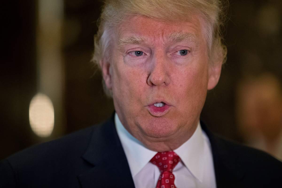 President-elect Donald Trump speaks to reporters in the lobby after meeting with French businessman Bernard Arnault, chief executive officer of LVMH, at Trump Tower, January 9, 2017 in New York City.