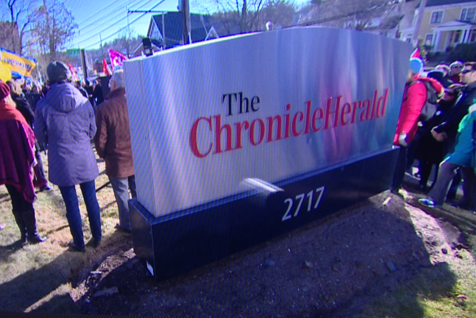 People gather outside the Halifax office of the Chronicle Herald on Joseph Howe Drive for a rally supporting striking workers at the newspaper who have been on strike since Jan. 23, 2016. 