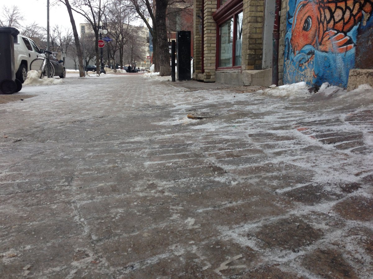 A thin sheet of ice covers most sidewalks in the Exchange District Monday.