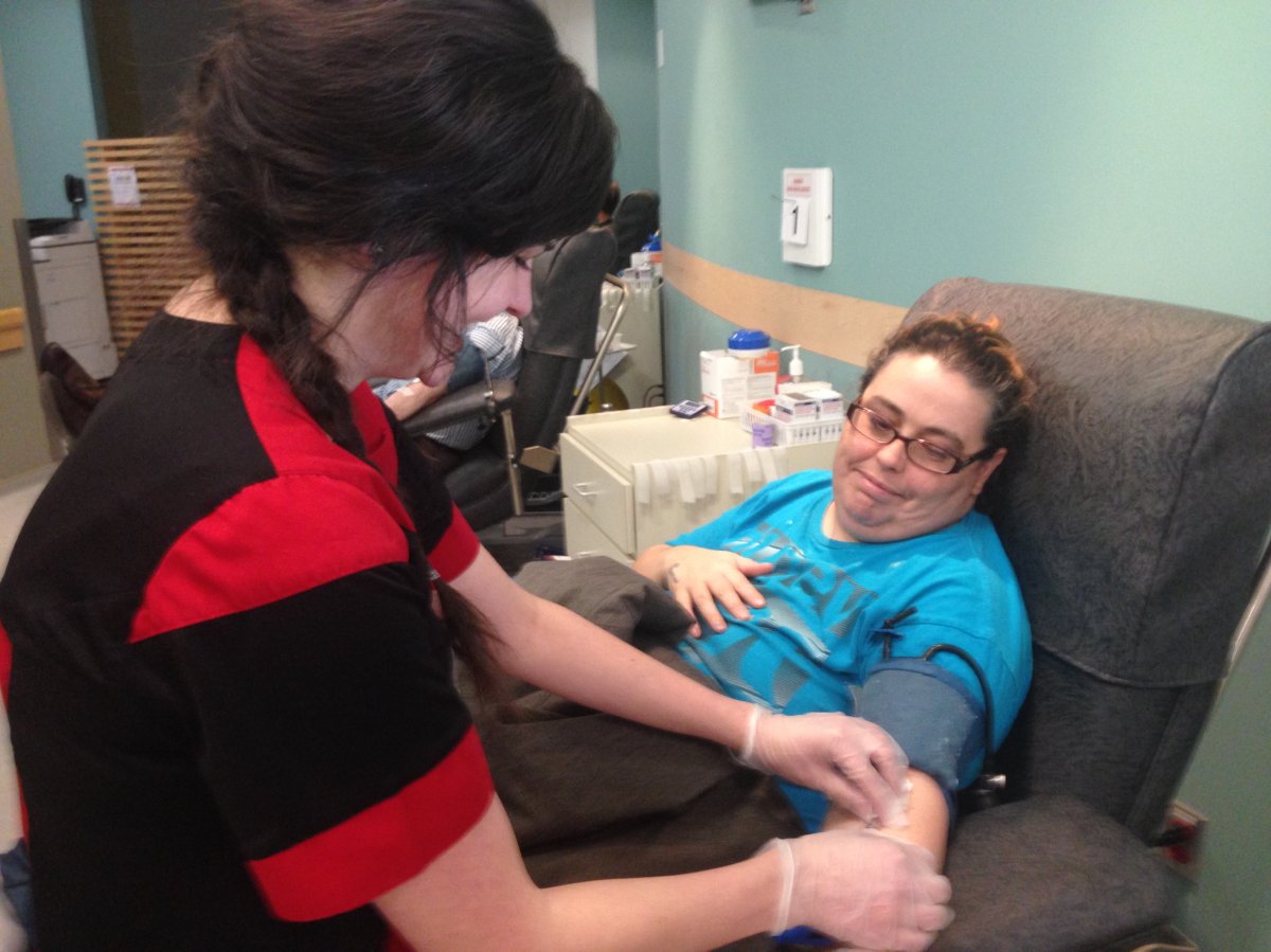 A woman donates blood in Halifax to help replenish the supply in New Brunswick after they lost two clinics due to the ice storm. 